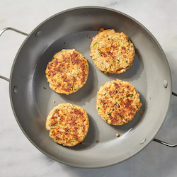 Easy Salmon Cakes four salmon cakes in a pan