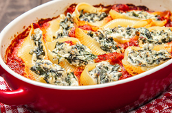 Easy Stuffed Pasta Shells stuffed pasta shells in a red casserole dish