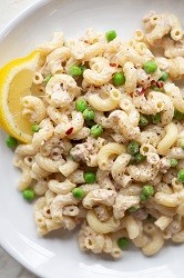 Tuna P Wiggle tuna pasta on a plate with lemon wedge garnish