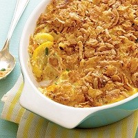 Lightened Squash Casserole Lightened Squash Casserole in a dish on a white and yellow towel