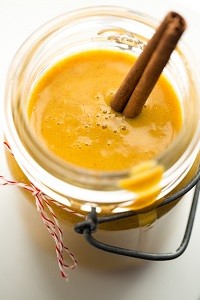 Velvety Butternut Cinnamon Date Smoothie for Two a mason jar with butternut cinnamon date smoothie and a cinnamon stick in it