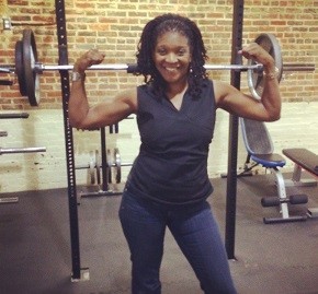 Elverna holding her arms in a strong pose in the gym Elverna holding her arms in a strong pose in the gym