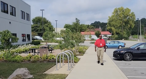 Stephen walking outside an office building