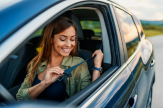 General Vehicle Safety Woman putting on seat belt