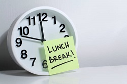 Clock with a Post-It Note that says Lunch Break! Breaks/Lunch