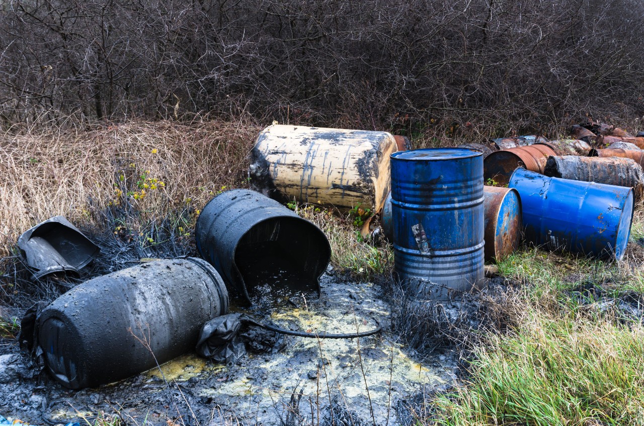Dumping Chemicals Barrels in a field