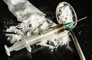 Drugs/Alcohol Needle with while powder in a spoon