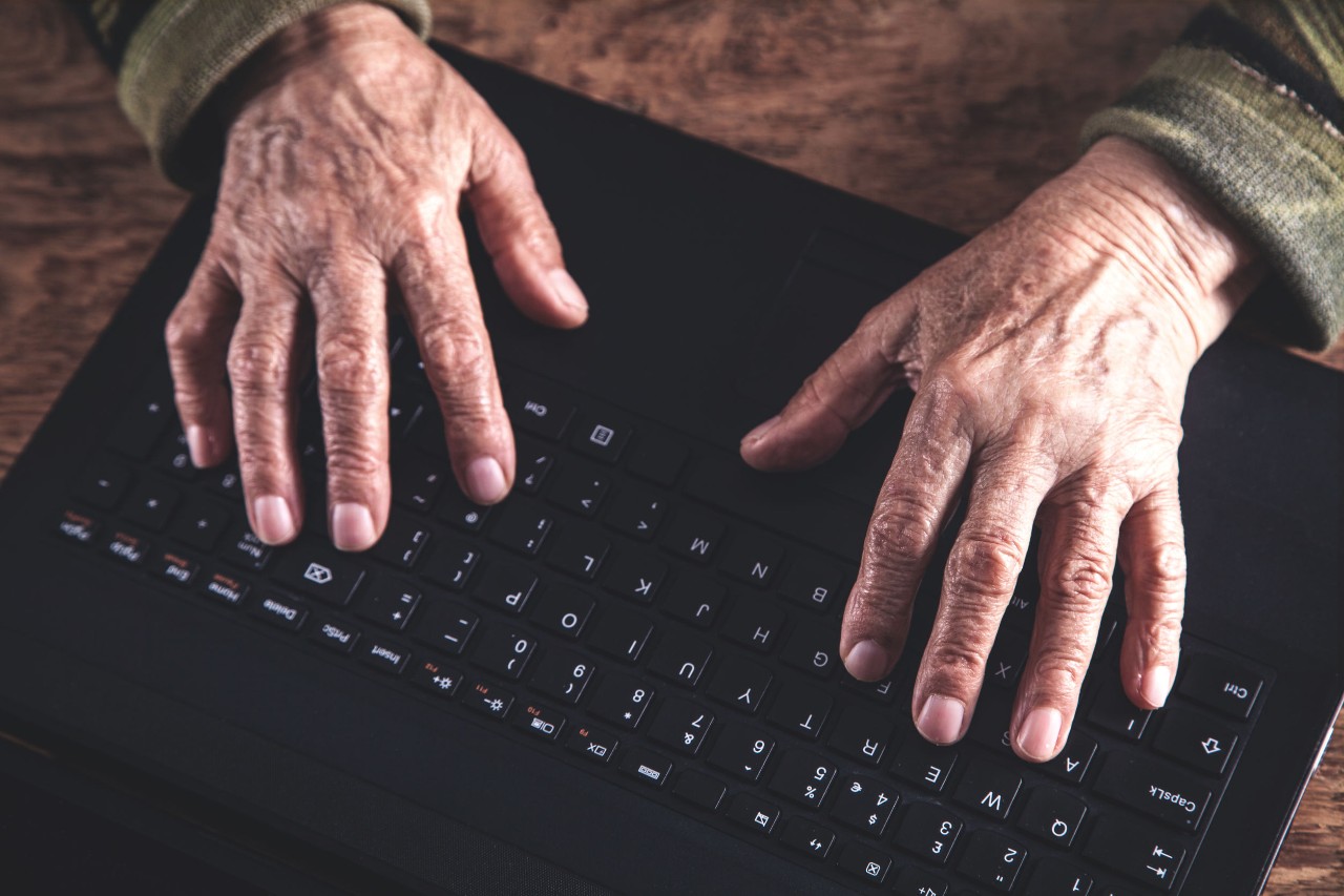 Age Discrimination Older person's hands on keyboard