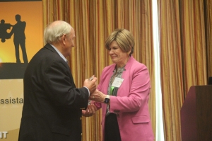 Abbie Hudgens, the BWC Administrator, presented Bob Pitts with the 2022 Sue Ann Head Award for Excellence in Workers' Compensation. Abbie Hudgens handing Bob Pitts the etched-glass award.