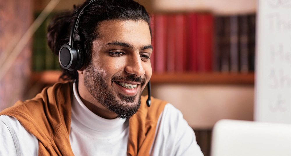 man-with-headset stock photo of man wearing headset at computer
