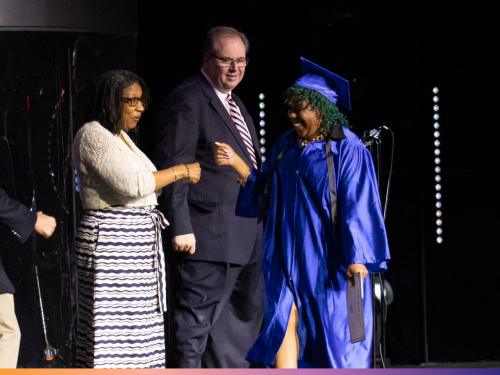 New Pathways Adult education learner accepts her diploma