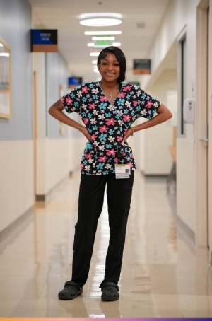 UpRise Nashville A female healthcare worker stands in the hallway of a hospital